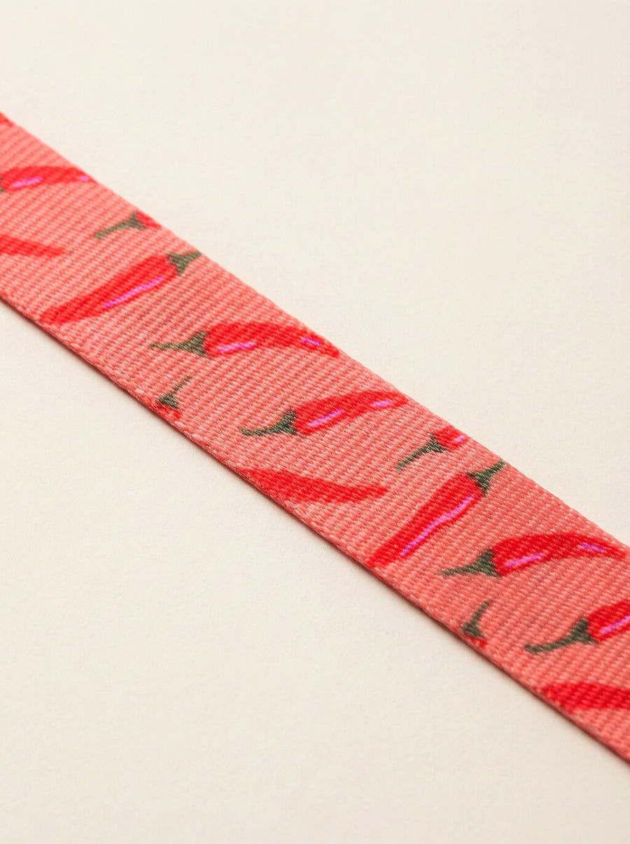Close up of the chili print on the collar and leash set from WOOF