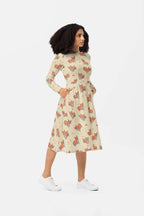 A person with curly hair stands in profile wearing the Dogloverclothing.com Cozy Corgi Long Sleeve Midi Dress adorned with a playful fox pattern. With hands in pockets and white sneakers, they strike a stylish and comfortable pose against a plain white background.
