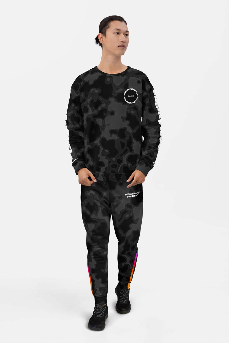 Person in Corgi Fan Club Elite Camo Joggers from WOOF, front view with black sneakers