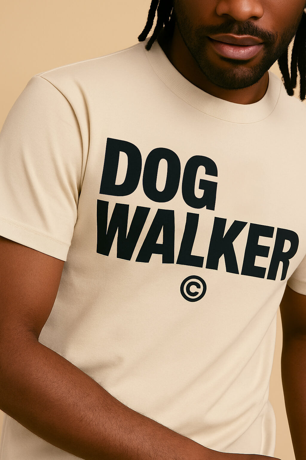 A person models the Dogloverclothing.com Relaxed Dog Walker© Unisex T-Shirt in light beige, featuring a bold front print. The photo shows the cropped torso and face, emphasizing its versatile unisex fit for dog walkers.