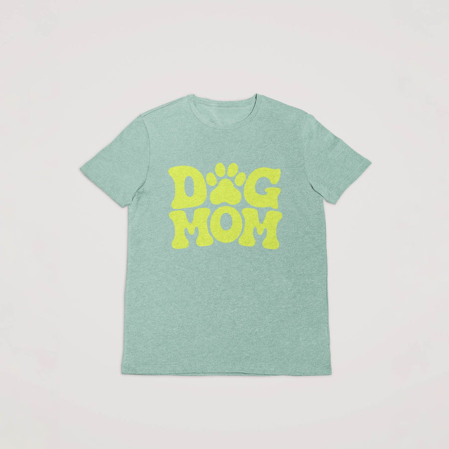 Light green Dog Mom T-Shirt from WOOF laid flat with yellow DOG MOM lettering and a paw print
