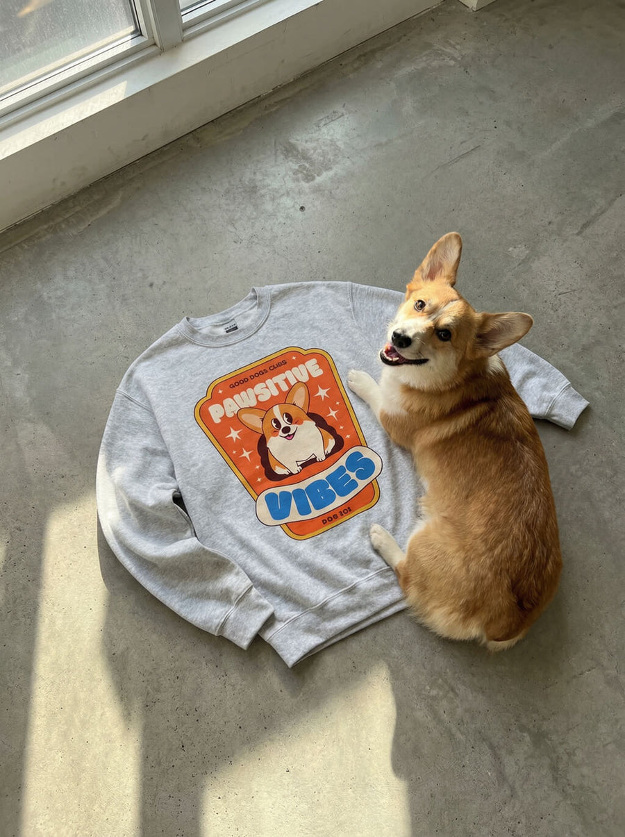 Front of the Pawsitive Vibes Corgi Sweatshirt from WOOF on a plain background