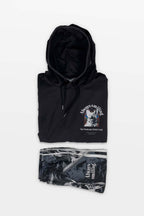 The Corgi Supreme Tribute Hoodie by Dogloverclothing.com in black features a cheerful Corgi graphic on the front, accompanied by matching monochrome joggers. Made from recycled materials, they are displayed folded on a white background, embodying eco-friendly fashion.