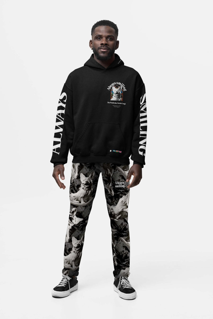 Man wearing the Corgi Supreme Tribute Joggers from WOOF with a black hoodie and black sneakers