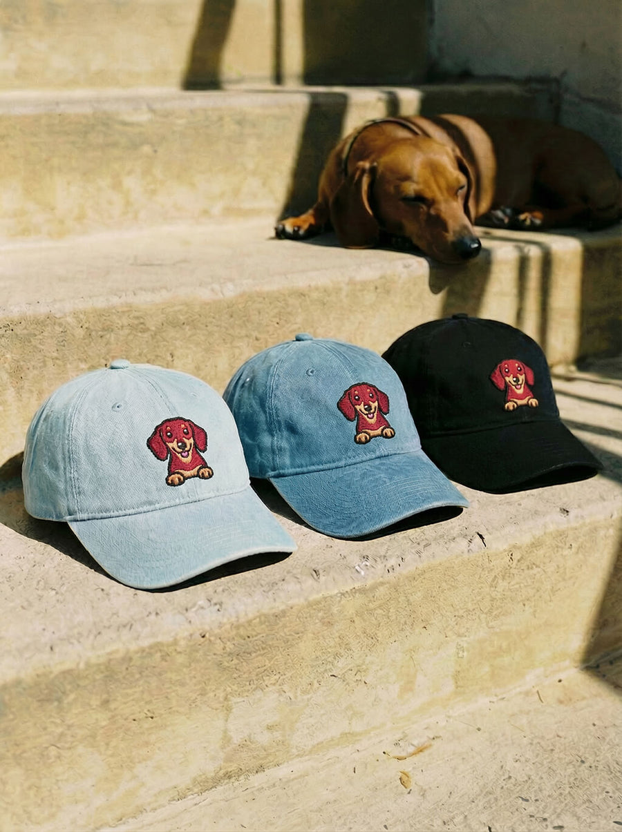 Dachshund embroidered denim caps from WOOF shown together