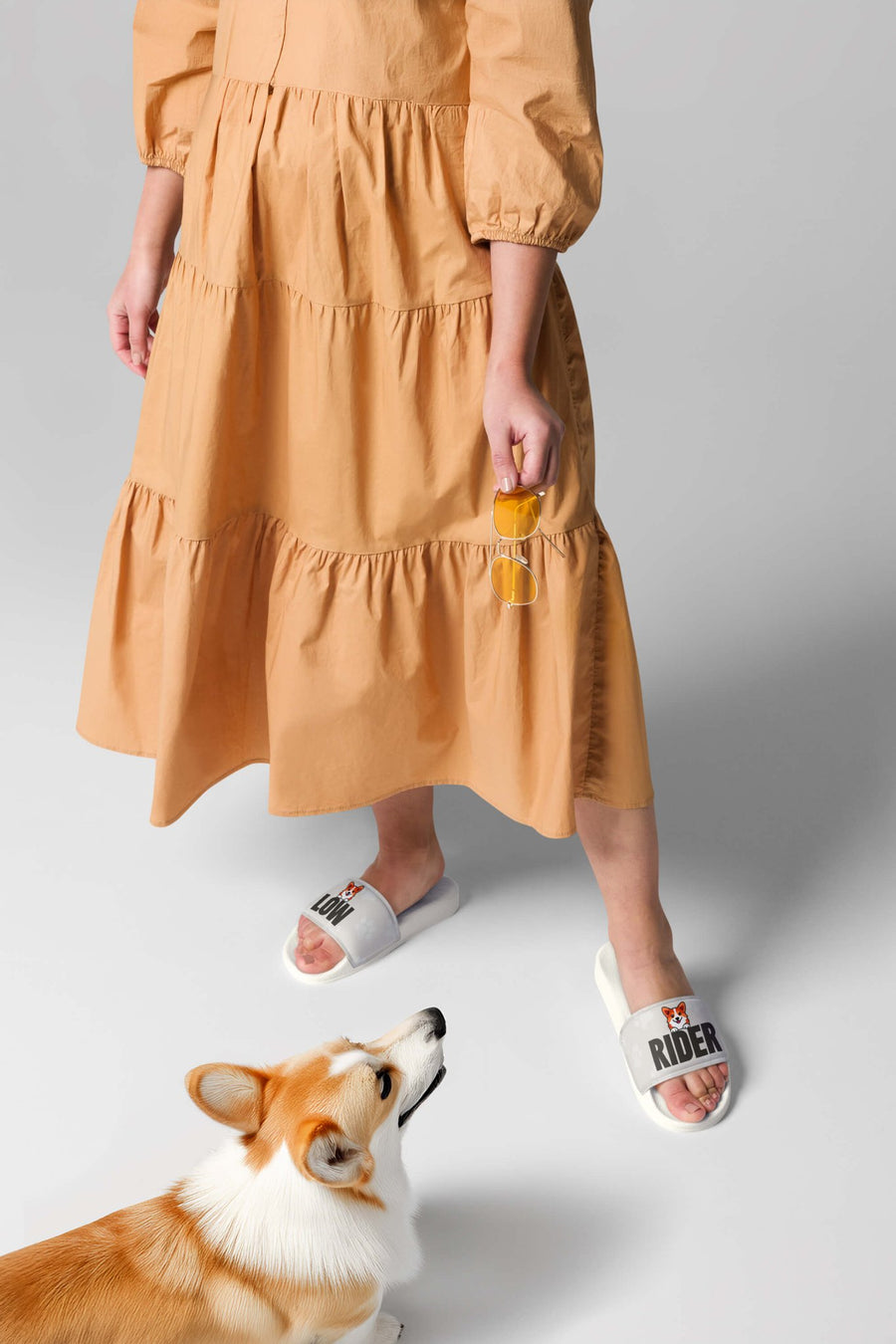 Person wearing the white Comfy Corgi Rider Slides from WOOF