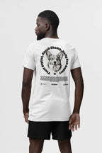 A man in a white Corgi Dad Ultimate Tribute T-Shirt from Dogloverclothing.com flaunts a smiling corgi graphic encircled by Snack Champion Club and Paws & Jaws, making it perfect for dog lovers. The unisex shirt pairs stylishly with black shorts, ideal for any canine enthusiast.