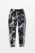 The Corgi Supreme Tribute Joggers from Dogloverclothing.com are black with a repeated wolf design and Always Smiling text on the upper left. Made from recycled materials, they feature white side stripes for a stylish, sustainable look.
