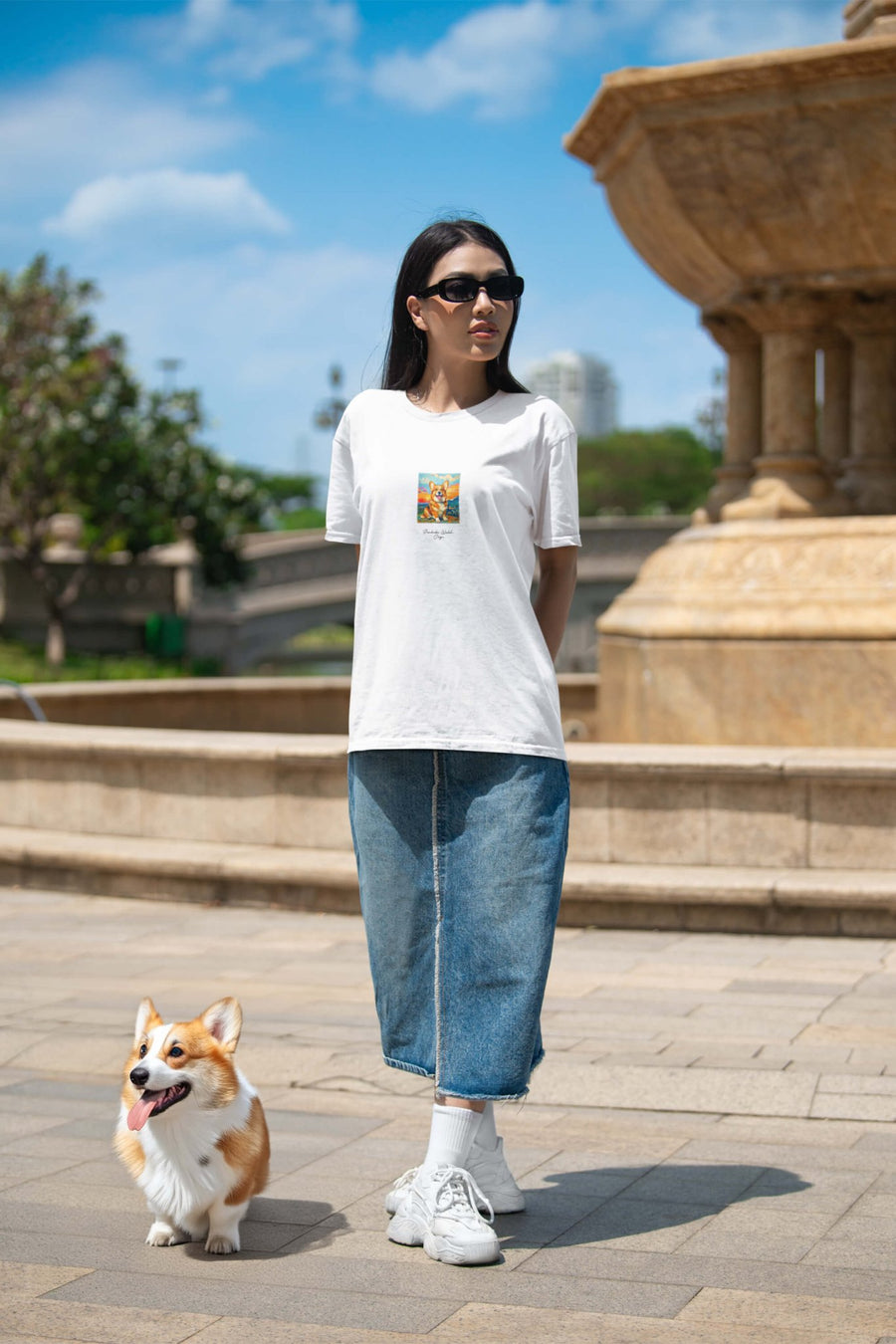 Model wearing the Poetic Corgi Joy T-Shirt from WOOF in an everyday setting