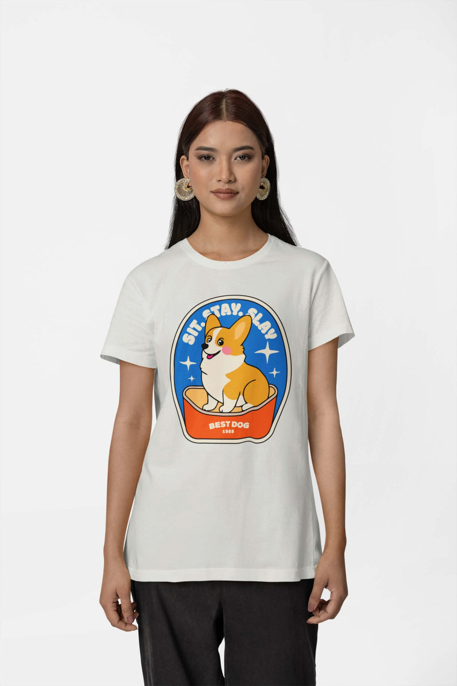 Woman in the white Best Dog T-Shirt from WOOF with the corgi mug graphic