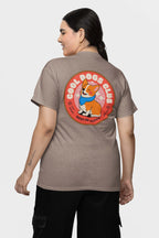 A woman models a Cool Dogs Club Unisex Hype T-Shirt from Dogloverclothing.com, featuring a vibrant cartoon dog graphic and Best in Class text on the back. Perfect for dog lovers and Corgi t-shirt fans, she smiles with her dark hair tied back as she faces away from the camera.