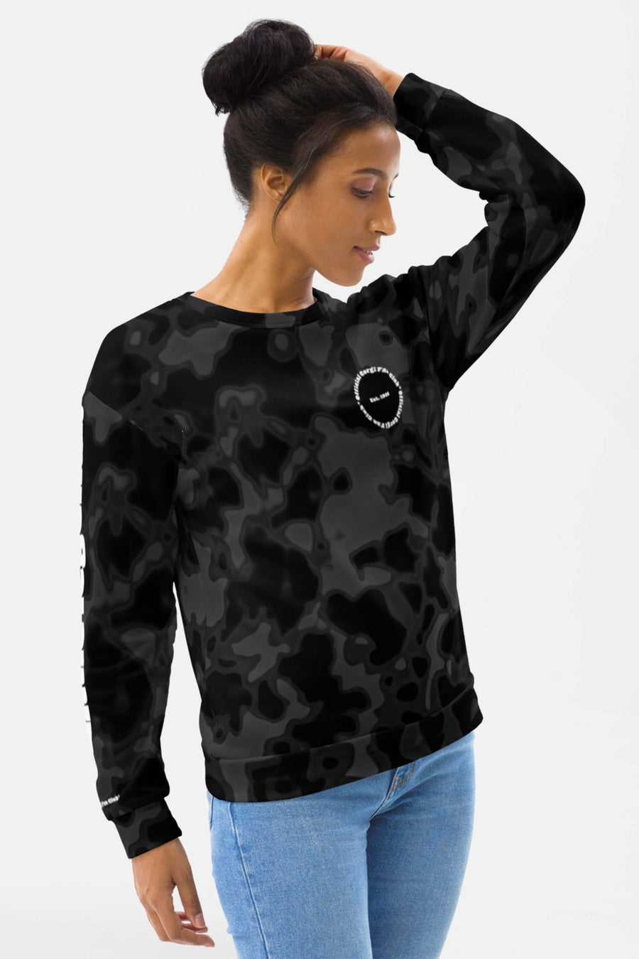 Woman smiling in the Corgi Fan Club Elite Camo Sweatshirt from WOOF with white sleeve and chest print