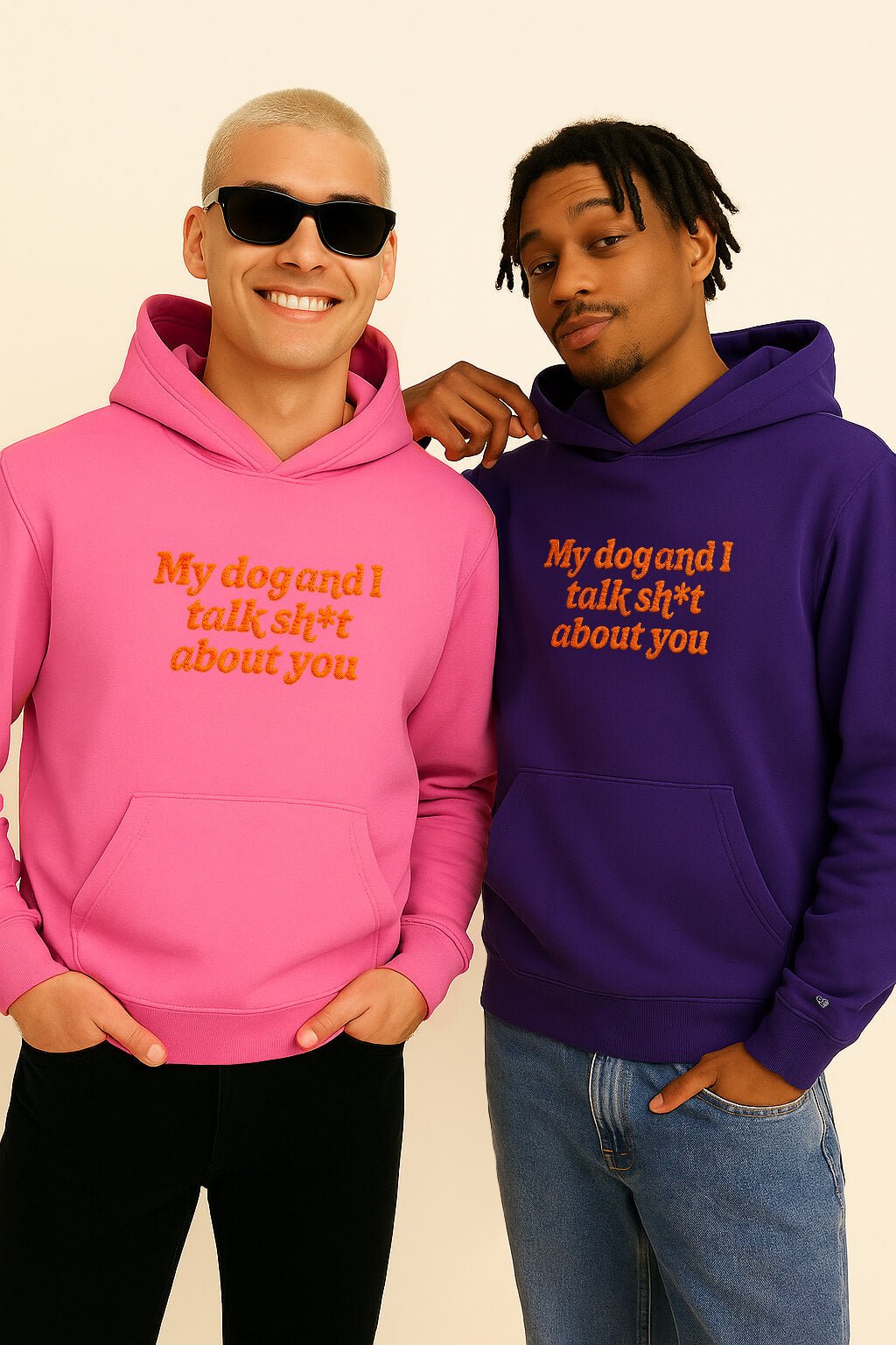 Two men smile side by side in Bold My Dog And I Talk Embroidered Hoodies from Dogloverclothing.com—one in pink with sunglasses, the other in purple with a hand on his friend’s shoulder—crafted from premium fabric for comfort.