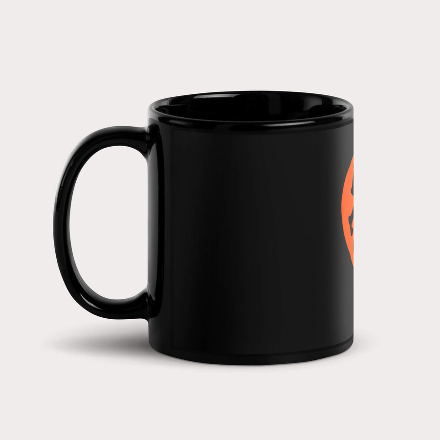 Dog Lover Mug from WOOF on a light grey surface, orange and black design seen from the side