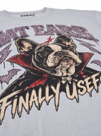 Close-up of the "Bat Ears – Finally Useful" print with a vampire French Bulldog on the Light Washed Denim tee