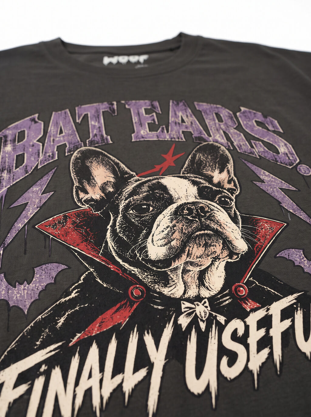 Close-up of the "Bat Ears – Finally Useful" print with a vampire French Bulldog on the Washed Black tee
