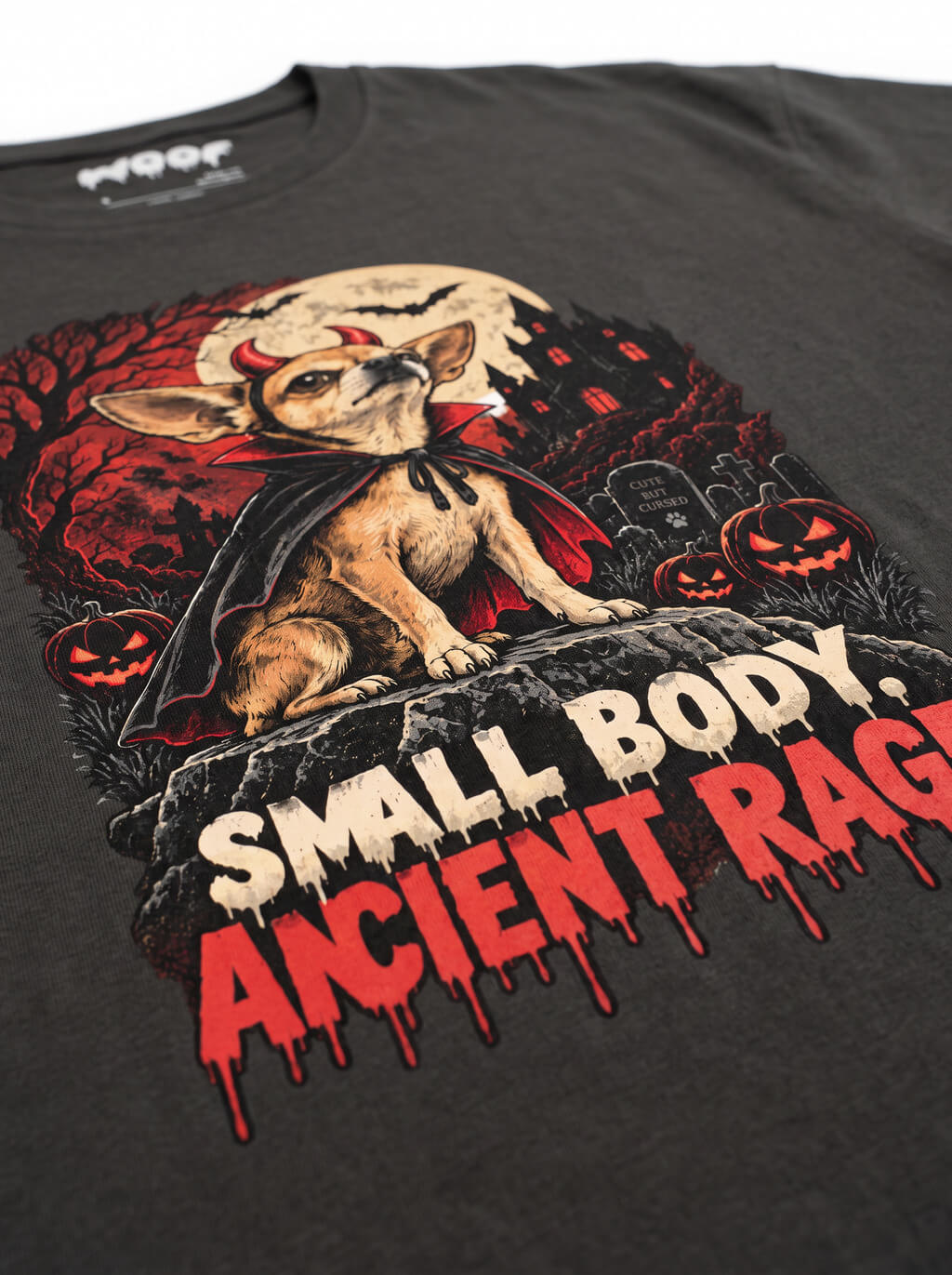 Close-up of the "Small Body. Ancient Rage." print with a Chihuahua in a haunted graveyard on the Washed Black tee
