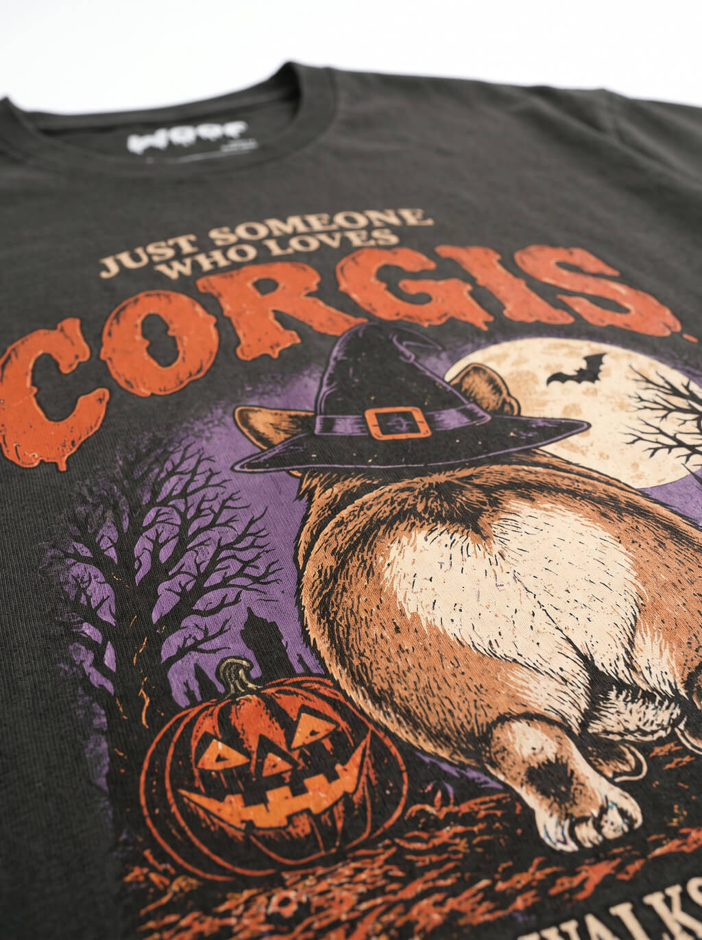 Close-up of the "Corgis" print with a Corgi butt in a witch hat on the Washed Black tee