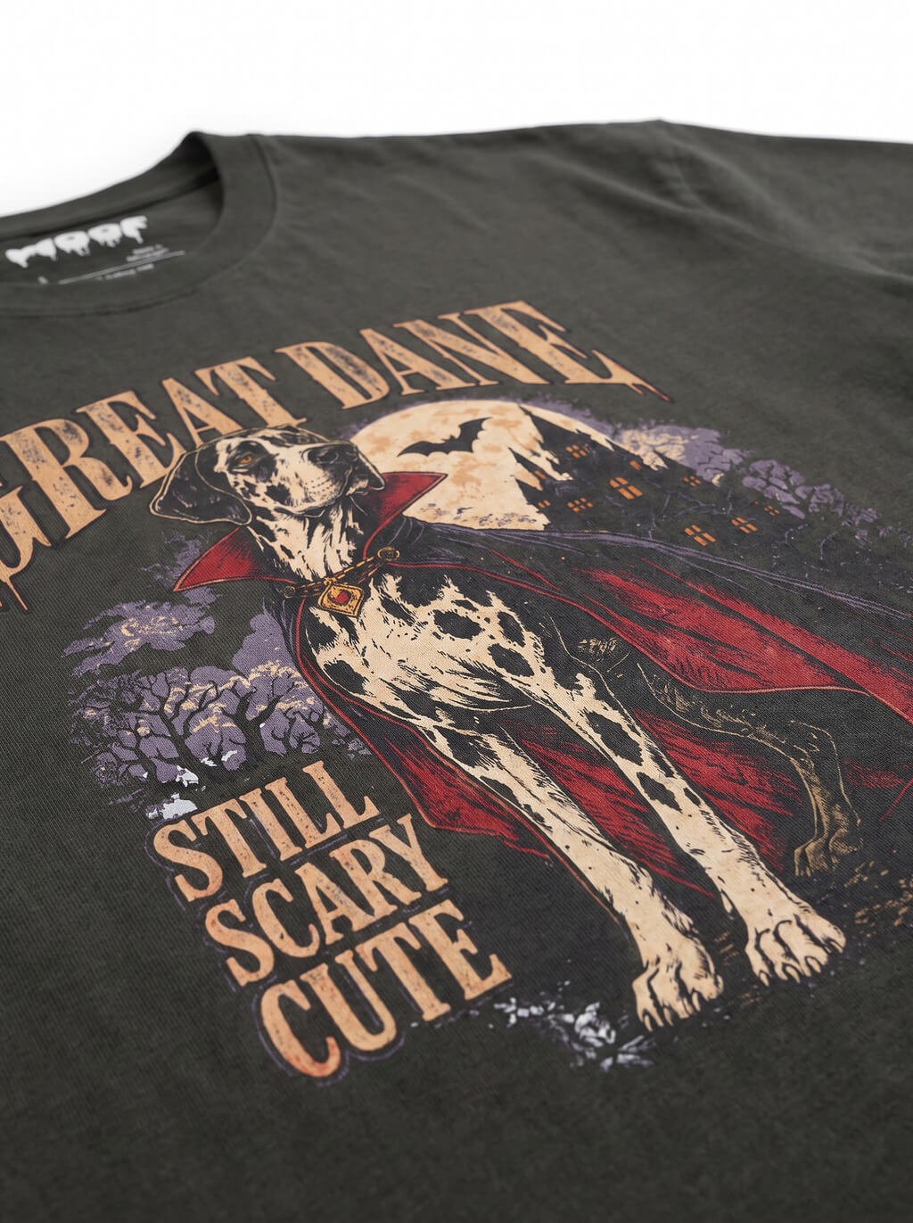 Close-up of the "Great Dane – Still Scary Cute" print with a Harlequin Great Dane in a vampire cape on the Washed Black tee