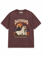Dachshund Halloween oversized T-shirt in Washed Maroon featuring a Dachshund ghost with a haunted house, front view