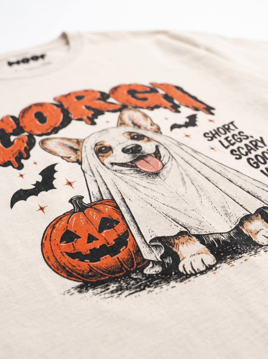 Close-up of the "Corgi – Short Legs, Scary Good Vibes" print with a Corgi in a ghost sheet on the Vintage White tee