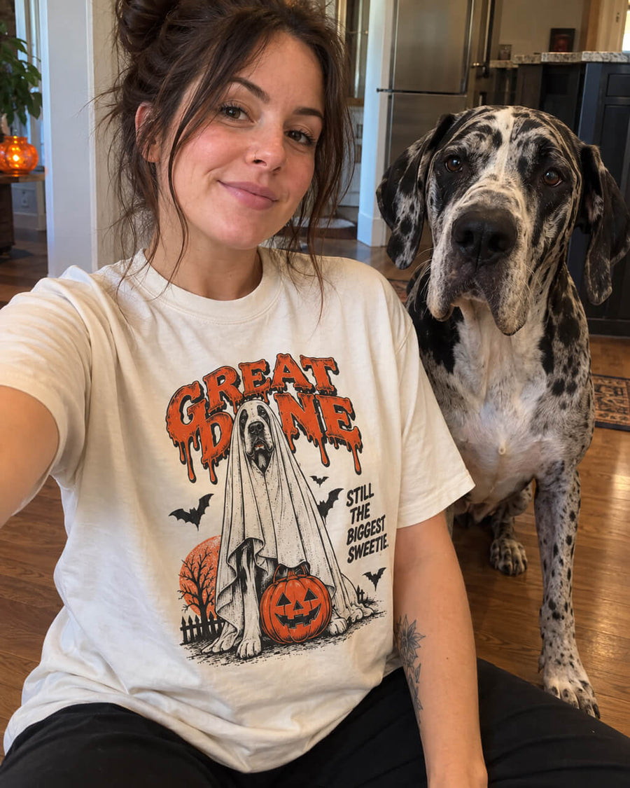 Ghost Mode Great Dane oversized Halloween T-shirt in Vintage White worn by a woman taking a selfie at home with her Harlequin Great Dane