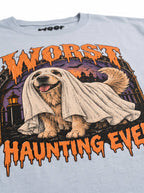 Close-up of the "Worst Haunting Ever" print with a Golden Retriever in a ghost sheet on the Light Washed Denim tee