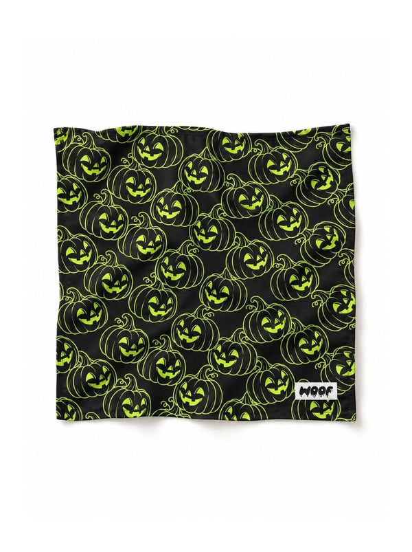 Green Pumpkin dog bandana in black with a neon green jack-o-lantern pattern, laid out flat
