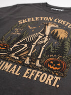 Close-up of the "Skeleton Costume. Minimal Effort." print with a Greyhound in a skeleton costume on the Washed Black tee
