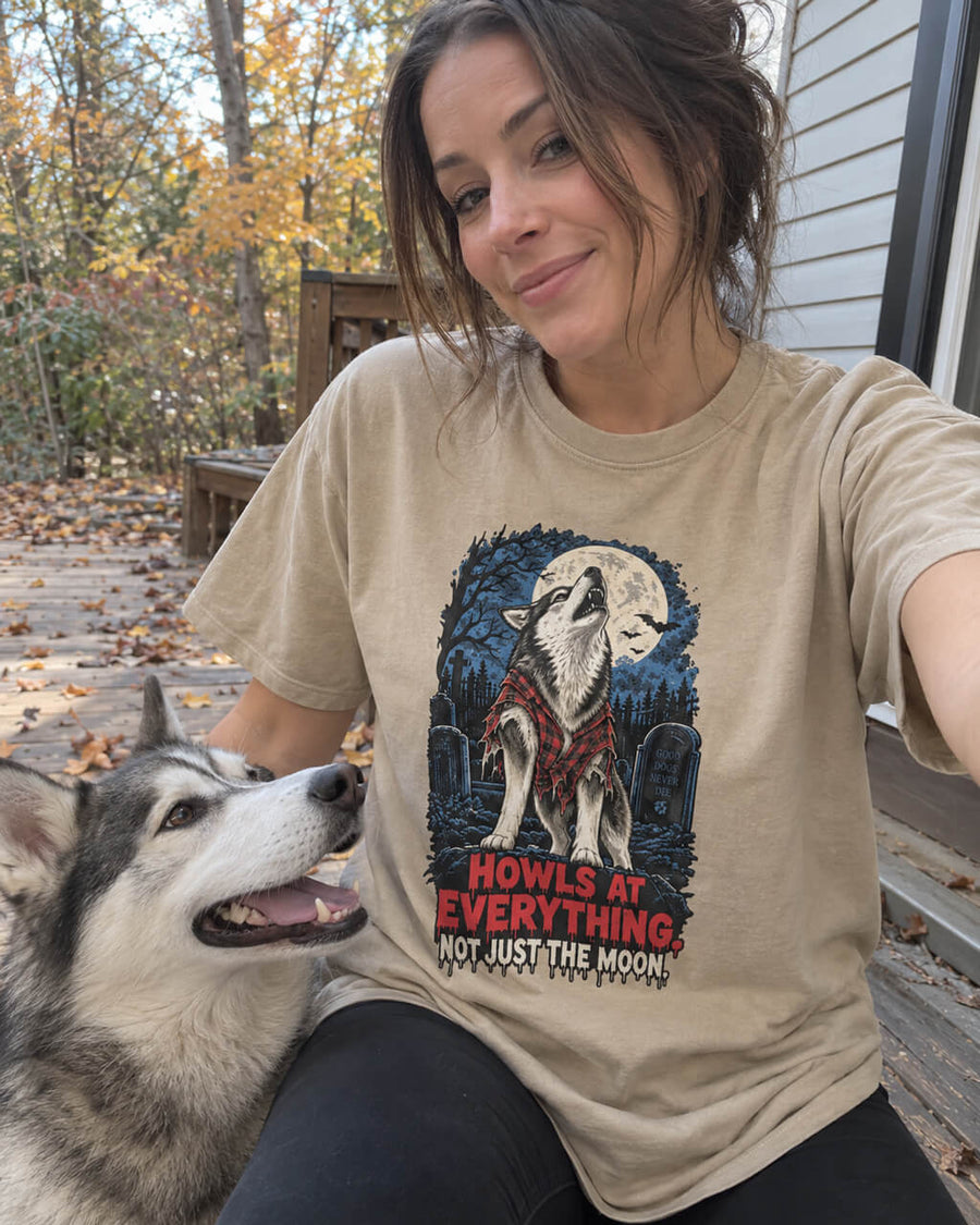 Husky Halloween oversized T-shirt in Khaki worn by a woman taking a selfie on an autumn deck with her Husky