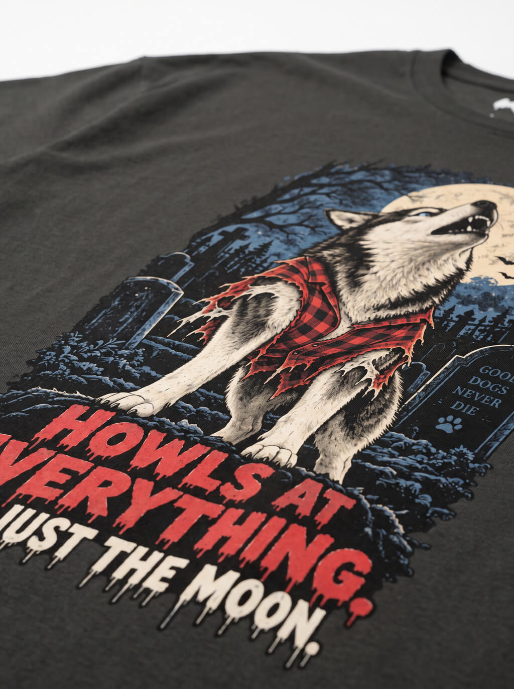 Close-up of the "Howls at Everything, Not Just the Moon" print with a Husky howling at the full moon on the Washed Black tee