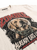 Close-up of the "Zombie – Already Eats Like One" print with a zombie Labrador on the Vintage White tee