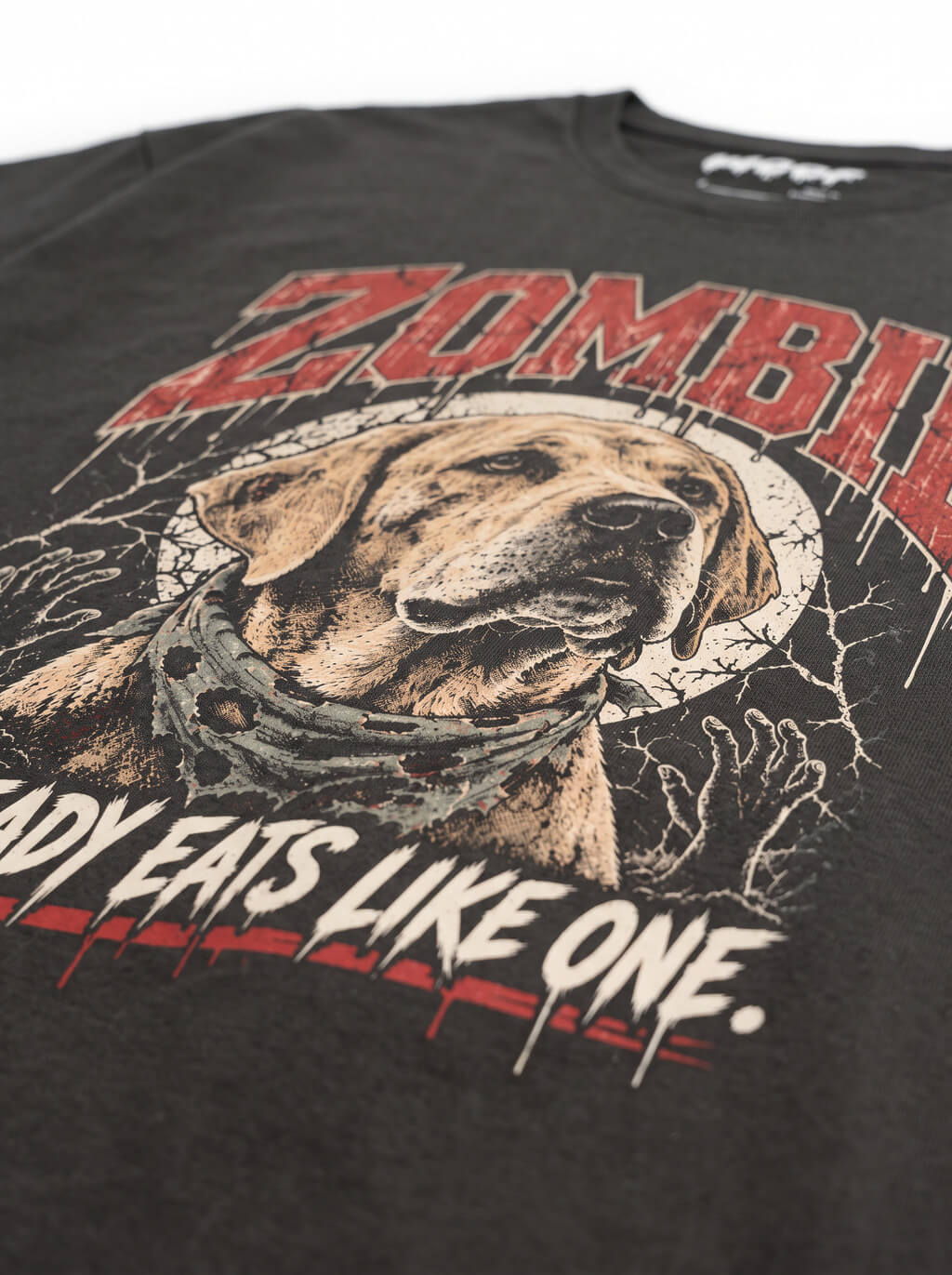 Close-up of the "Zombie – Already Eats Like One" print with a zombie Labrador on the Washed Black tee