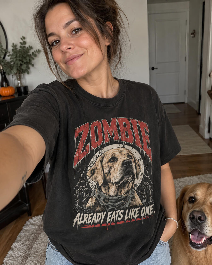 Labrador Halloween oversized T-shirt in Washed Black worn by a woman taking a selfie at home with her Labrador