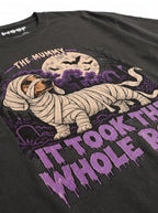 Close-up of the "It Took the Whole Roll" print with a mummy-wrapped Dachshund on the Washed Black tee