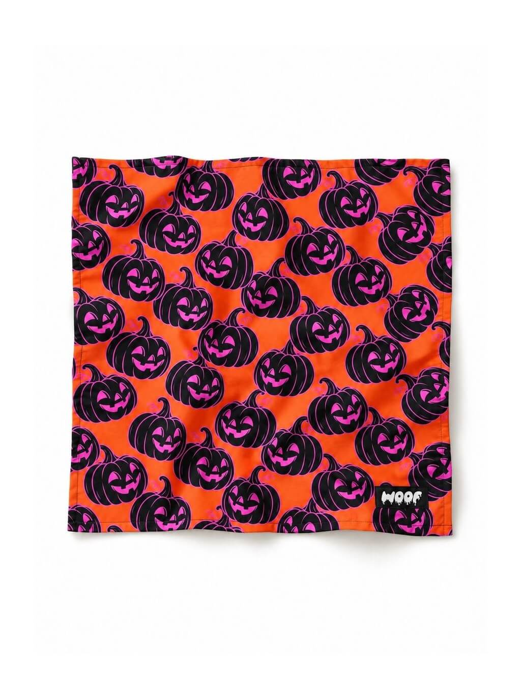 Orange Pumpkin dog bandana in orange with a black and pink jack-o-lantern pattern, laid out flat