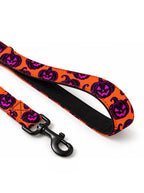 Close-up of the padded Orange Pumpkin leash handle with jack-o-lantern print and matte black snap hook