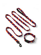 Orange Pumpkin dog collar and leash set in orange with a black and pink jack-o-lantern print, laid out flat