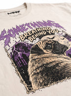 Close-up of the "Something Breathing Behind You" print with a Pug looking back in a spooky graveyard on the Vintage White tee