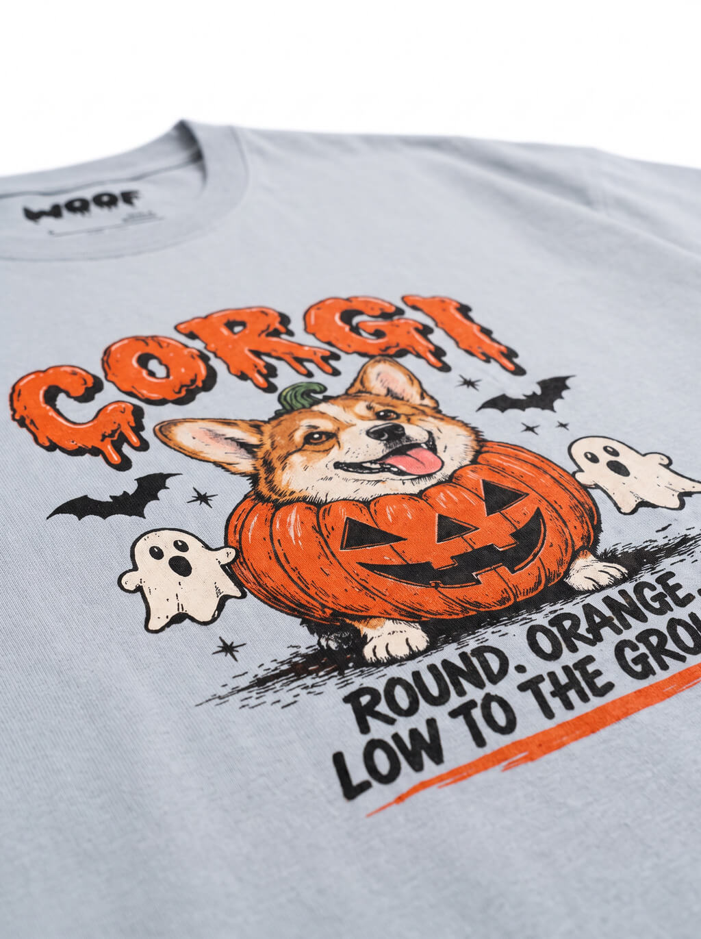 Close-up of the "Corgi – Round. Orange. Low to the Ground." print with a Corgi in a jack-o'-lantern with little ghosts on the Light Washed Denim tee