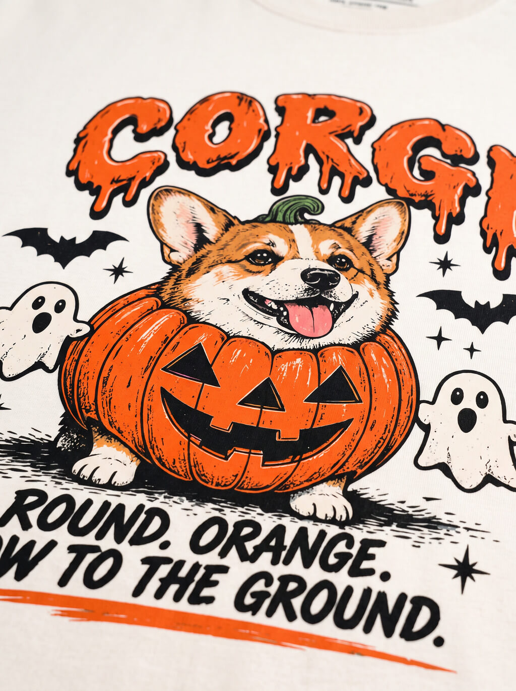 Close-up of the "Corgi – Round. Orange. Low to the Ground." print with a Corgi in a jack-o'-lantern with little ghosts on the Vintage White tee