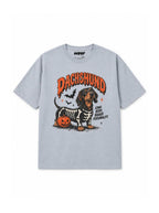 Skeleton Dachshund oversized Halloween T-shirt in Light Washed Denim featuring a Dachshund in a skeleton costume with pumpkins, front view