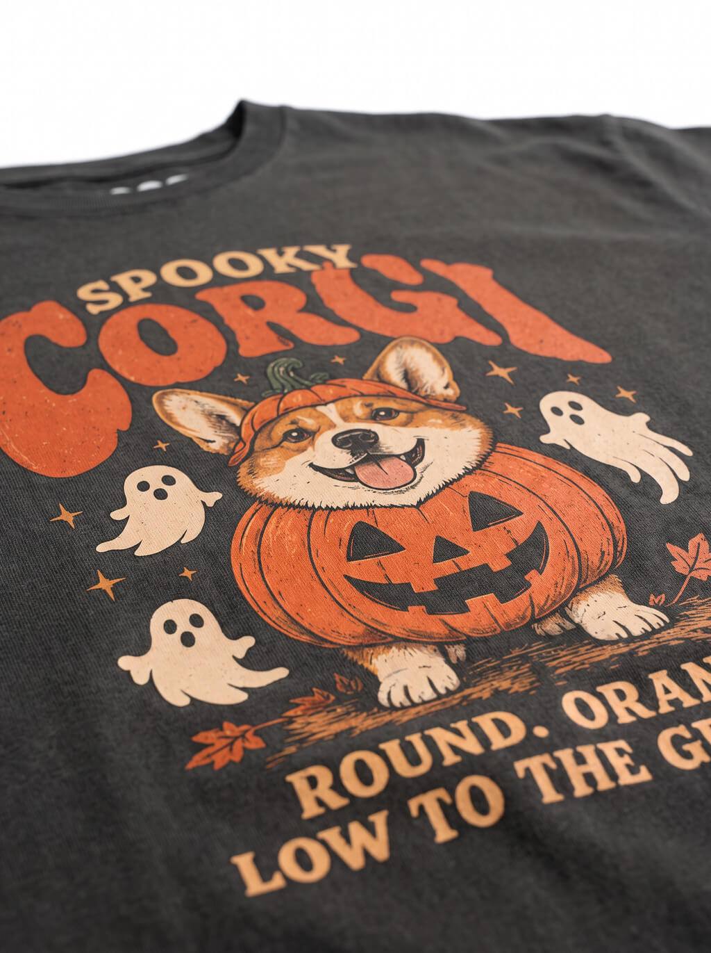 Close-up of the "Spooky Corgi" print with a Corgi in a jack-o'-lantern with ghosts on the Washed Black tee