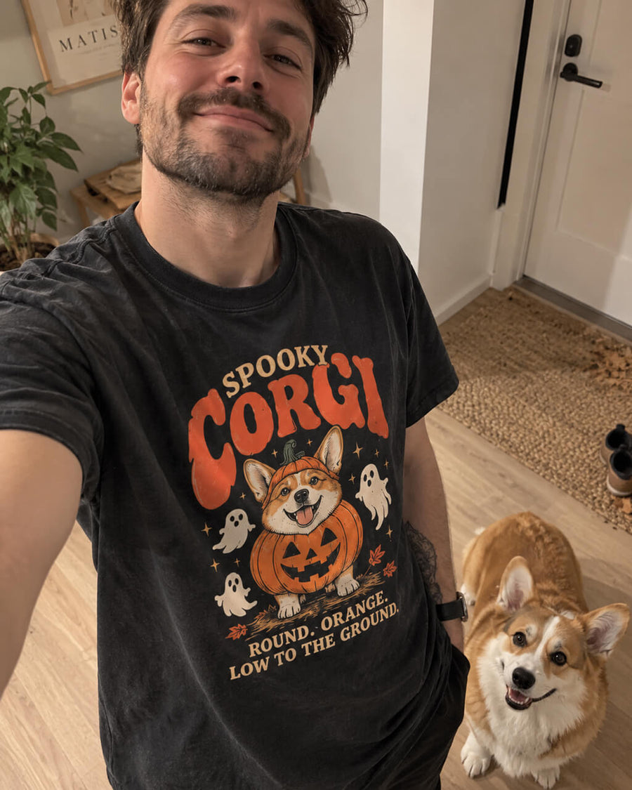 Spooky Corgi oversized Halloween T-shirt in Washed Black worn by a man taking a selfie at home with his Corgi