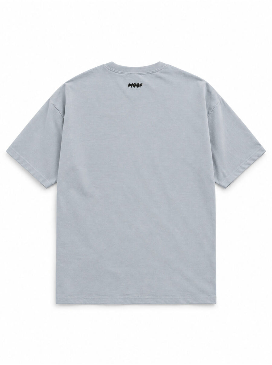 Back of the Treat First Corgi oversized Halloween T-shirt in Light Washed Denim with small WOOF logo below the collar