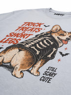 Close-up of the "Trick, Treats & Short Legs" print with a Corgi in a skeleton costume on the Light Washed Denim tee